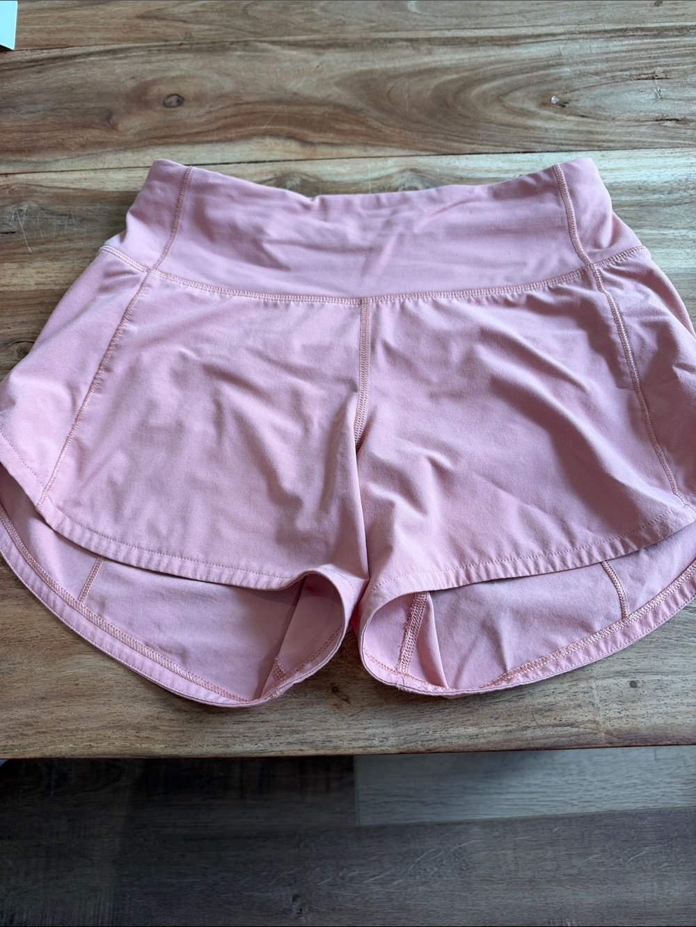 Lululemon subtle peach/creamy color shorts.